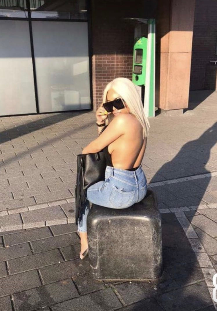 Model wearing blonde balayage 14-inch HD lace human hair wig in body wave texture – Nuola Wigs.