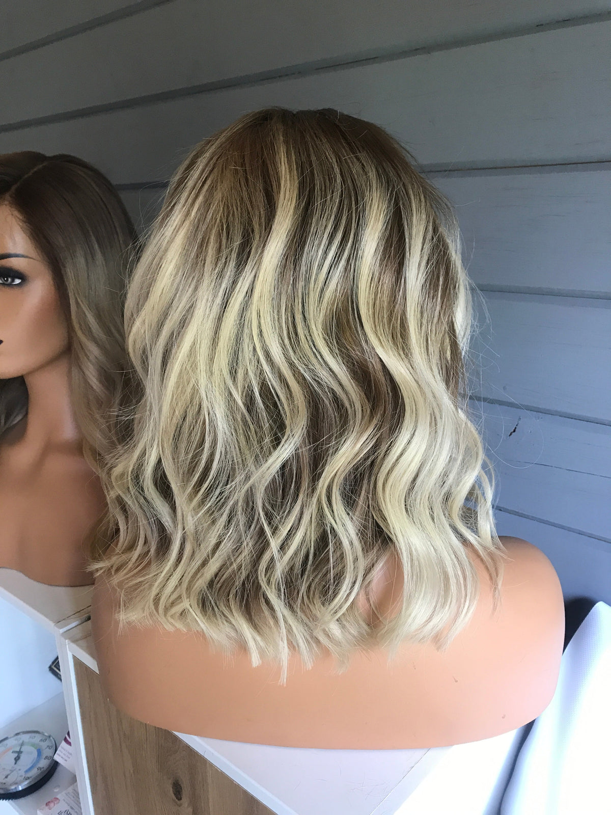 Model wearing blonde balayage 14-inch HD lace human hair wig in body wave texture – Nuola Wigs.