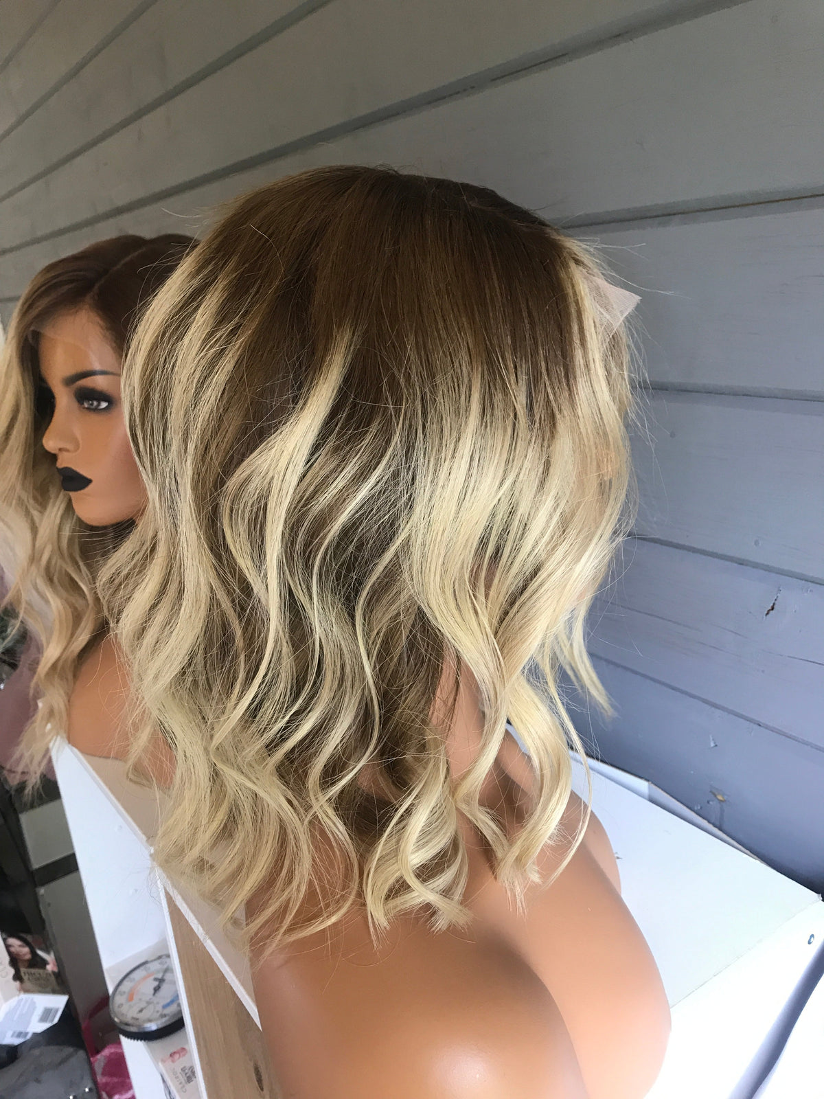 Model wearing blonde balayage 14-inch HD lace human hair wig in body wave texture – Nuola Wigs.