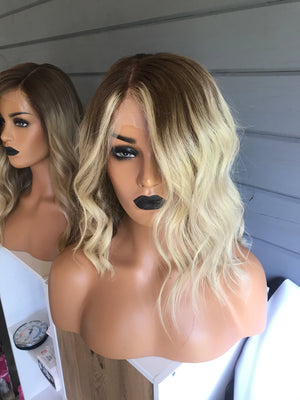 Model wearing blonde balayage 14-inch HD lace human hair wig in body wave texture – Nuola Wigs.