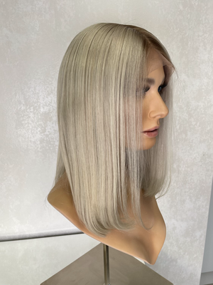 Model wearing blonde balayage 14-inch HD lace human hair wig in body wave texture – Nuola Wigs.