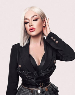 Model wearing blonde balayage 14-inch HD lace human hair wig in body wave texture – Nuola Wigs.