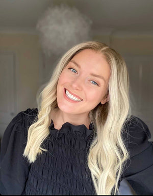 Model wearing blonde balayage 18-inch HD lace human hair wig in body wave texture – Nuola Wigs.