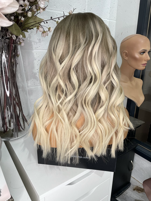 Model wearing blonde balayage 18-inch HD lace human hair wig in body wave texture – Nuola Wigs.