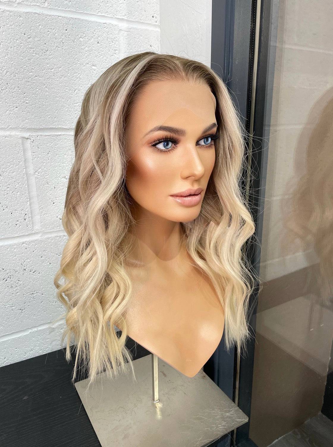 Model wearing blonde balayage 18-inch HD lace human hair wig in body wave texture – Nuola Wigs.