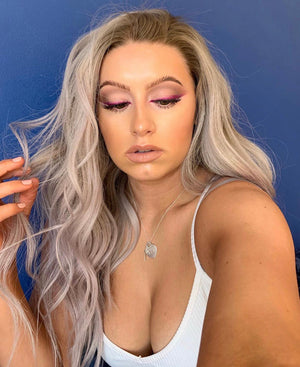 Model wearing blonde balayage 18-inch HD lace human hair wig in body wave texture – Nuola Wigs.