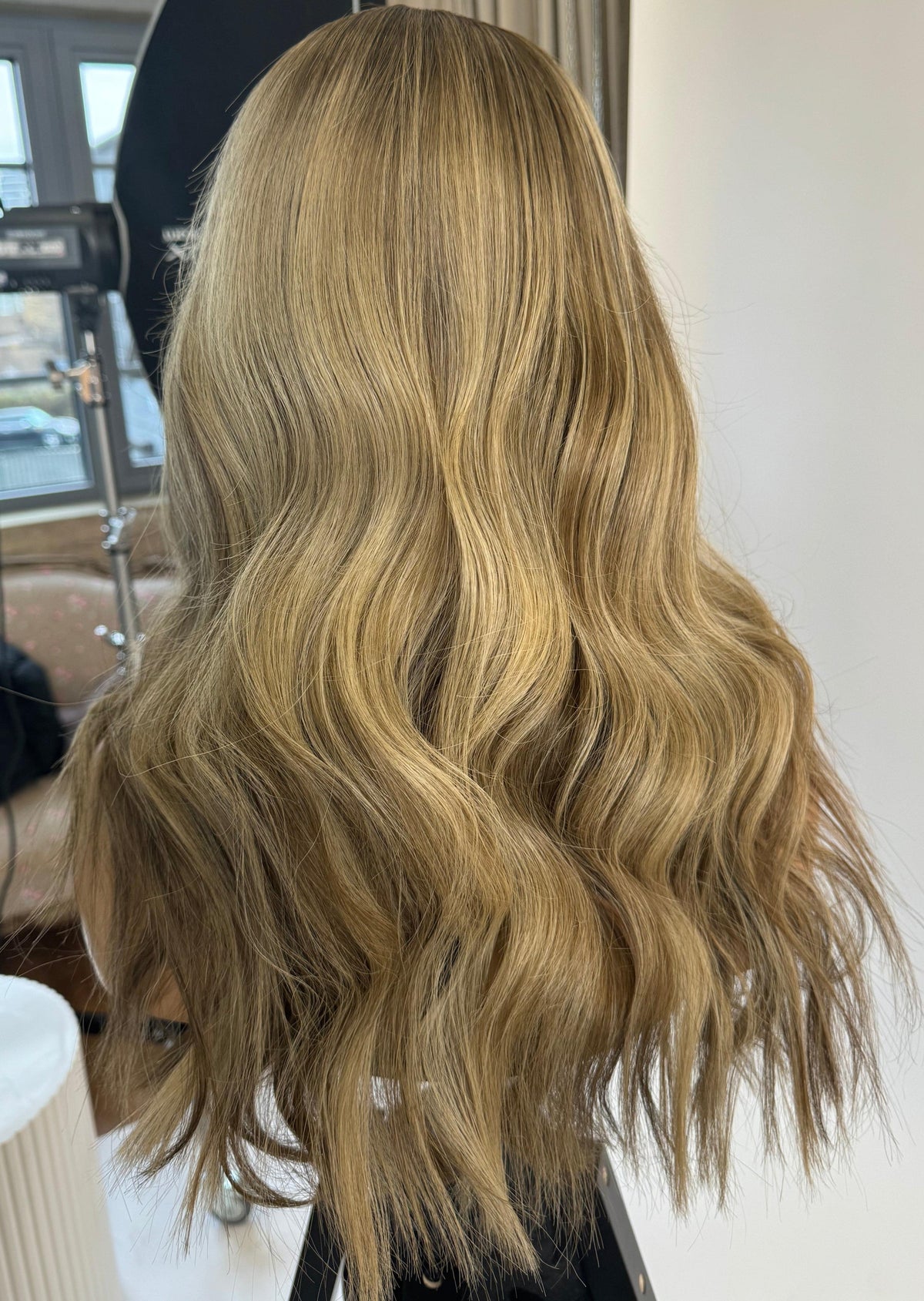 Model wearing blonde balayage 18-inch HD lace human hair wig in body wave texture – Nuola Wigs.