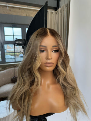 Model wearing blonde balayage 20-inch HD lace human hair wig in body wave texture – Nuola Wigs.