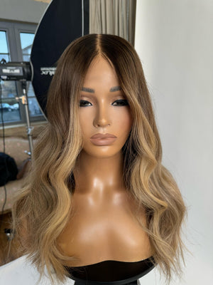 Model wearing blonde balayage 20-inch HD lace human hair wig in body wave texture – Nuola Wigs.