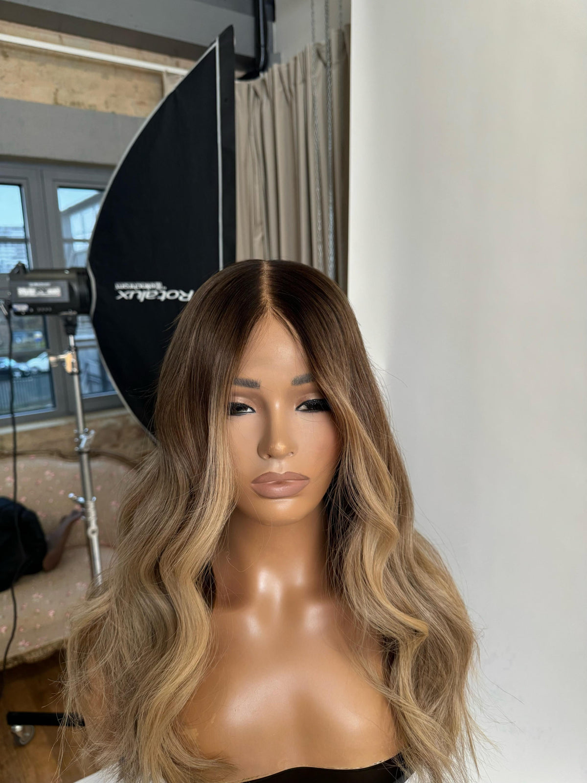 Model wearing blonde balayage 20-inch HD lace human hair wig in body wave texture – Nuola Wigs.