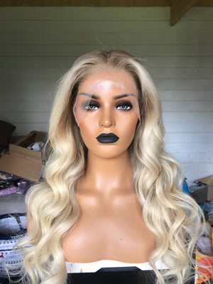Model wearing blonde balayage 22-inch HD lace human hair wig in body wave texture – Nuola Wigs.