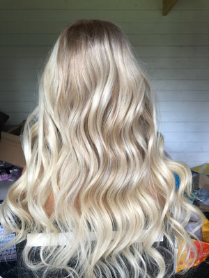 Model wearing blonde balayage 22-inch HD lace human hair wig in body wave texture – Nuola Wigs.