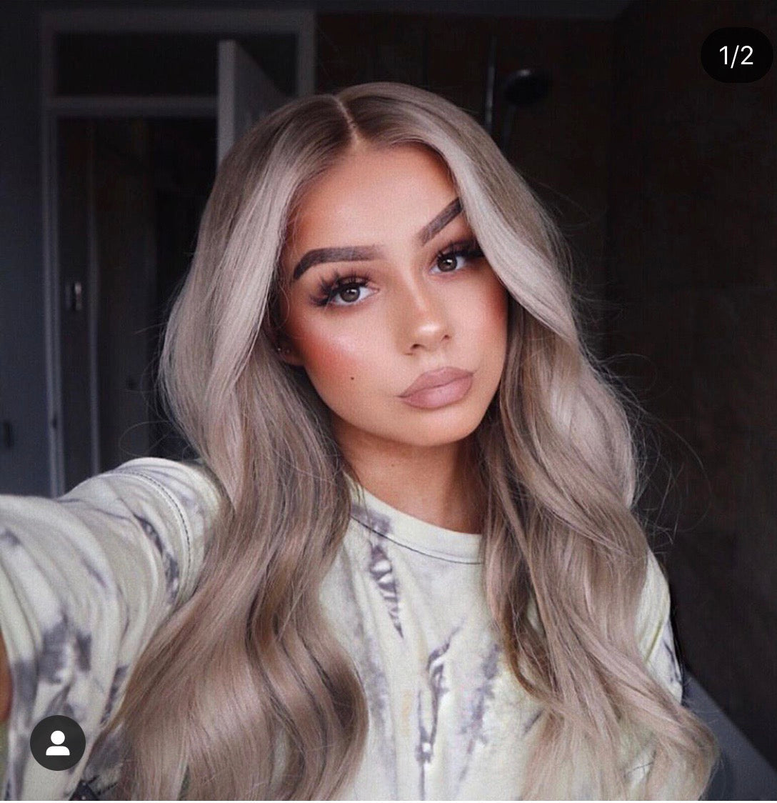 Model wearing blonde balayage 22-inch HD lace human hair wig in body wave texture – Nuola Wigs.