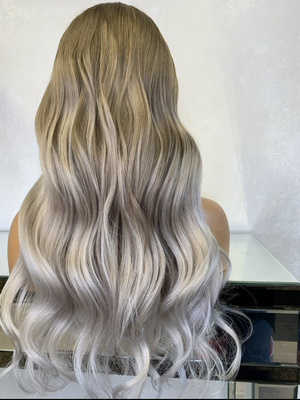 Model wearing blonde balayage 22-inch HD lace human hair wig in body wave texture – Nuola Wigs.