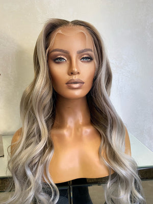 Model wearing blonde balayage 22-inch HD lace human hair wig in body wave texture – Nuola Wigs.