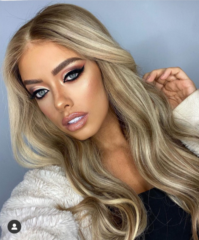 Model wearing blonde balayage 22-inch HD lace human hair wig in body wave texture – Nuola Wigs.