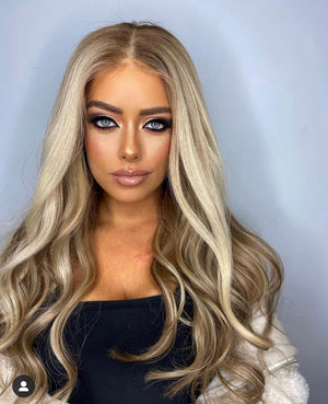 Model wearing blonde balayage 22-inch HD lace human hair wig in body wave texture – Nuola Wigs.