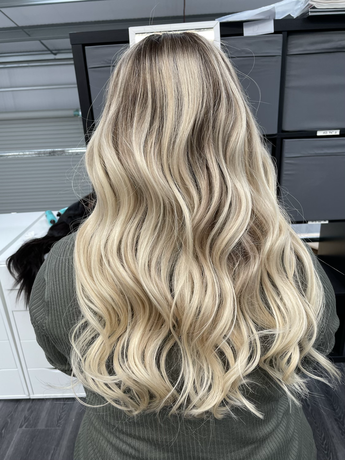 Model wearing blonde balayage 22-inch HD lace human hair wig in body wave texture – Nuola Wigs.