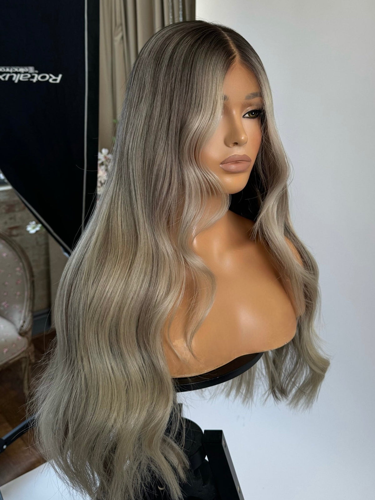 Model wearing blonde balayage 24-inch HD lace human hair wig in body wave texture – Nuola Wigs.