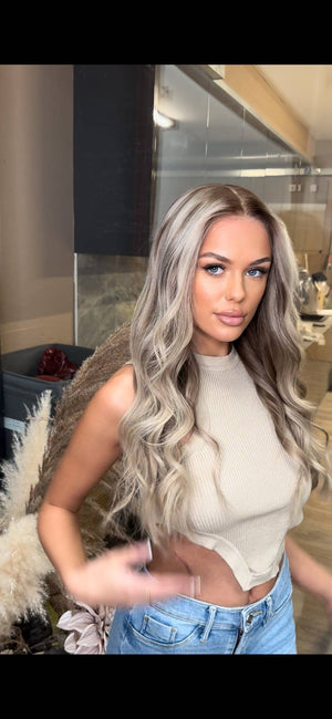 Model wearing blonde balayage 24-inch HD lace human hair wig in body wave texture – Nuola Wigs.