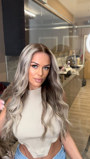 Model wearing blonde balayage 24-inch HD lace human hair wig in body wave texture – Nuola Wigs.