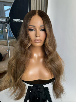 Model wearing blonde balayage 24-inch HD lace human hair wig in body wave texture – Nuola Wigs.
