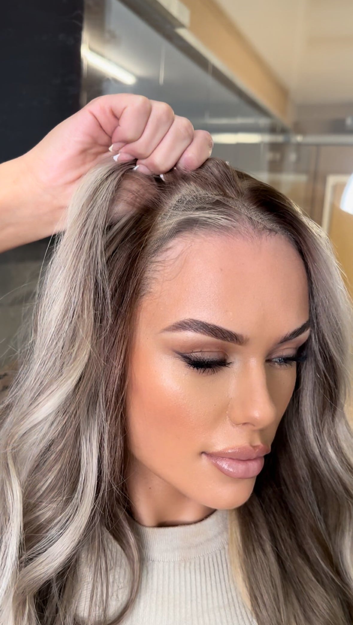 Model wearing blonde balayage 24-inch HD lace human hair wig in body wave texture – Nuola Wigs.