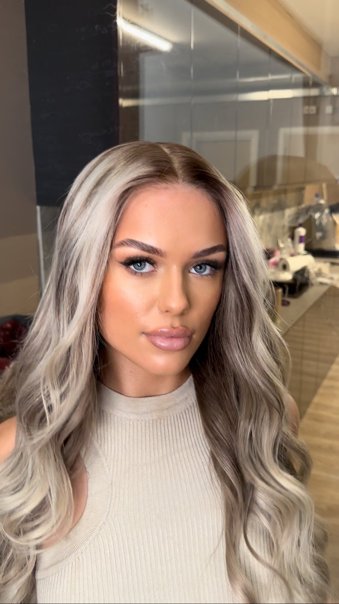 Model wearing blonde balayage 24-inch HD lace human hair wig in body wave texture – Nuola Wigs.