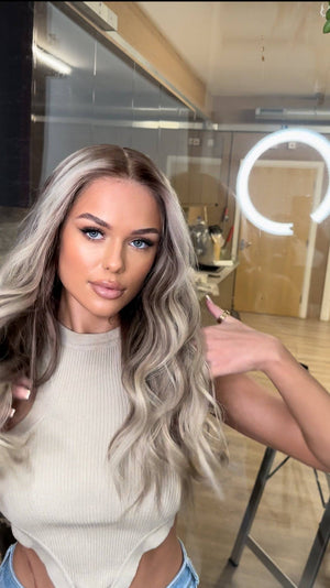 Model wearing blonde balayage 24-inch HD lace human hair wig in body wave texture – Nuola Wigs.