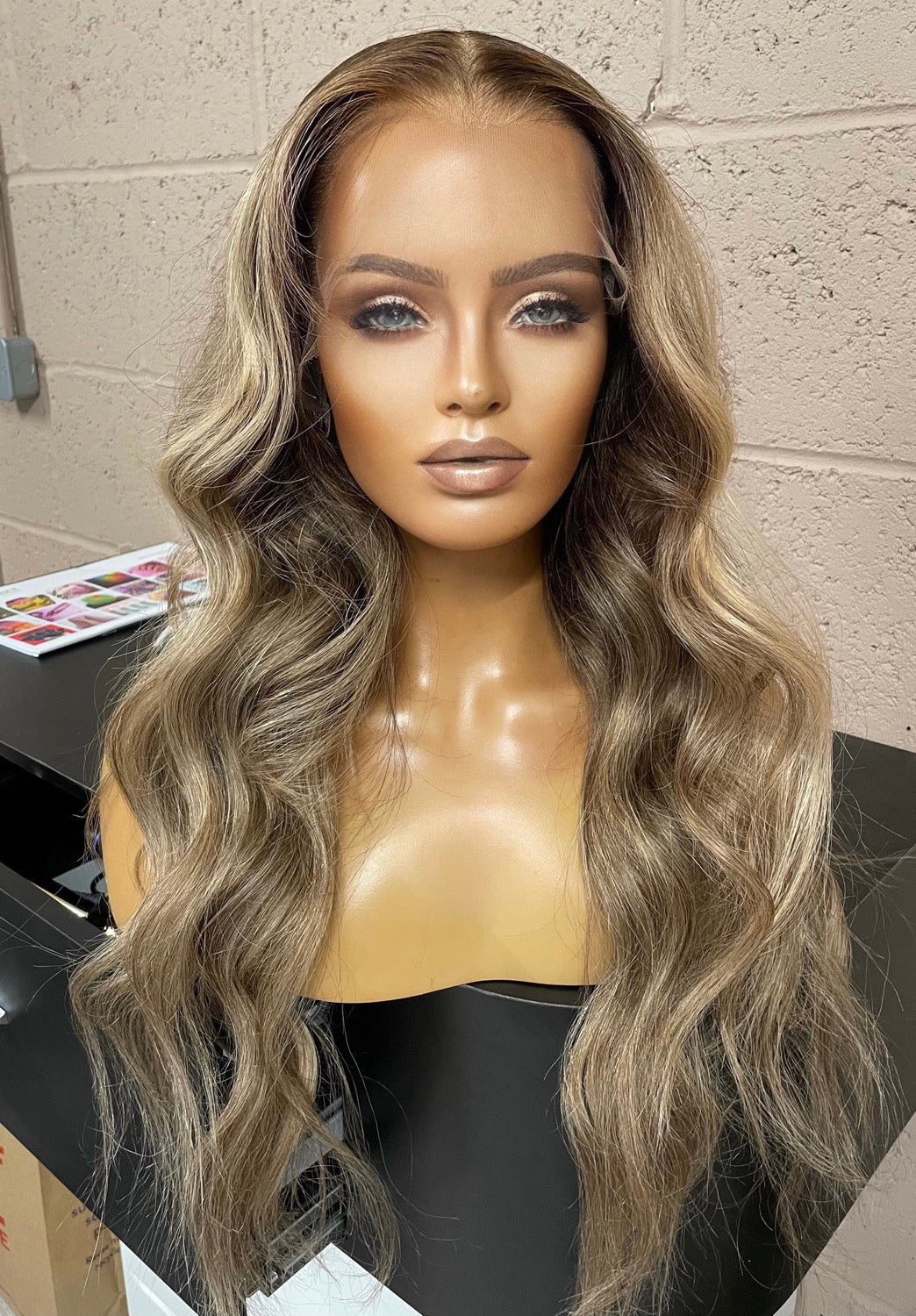 Model wearing blonde balayage 24-inch HD lace human hair wig in body wave texture – Nuola Wigs.