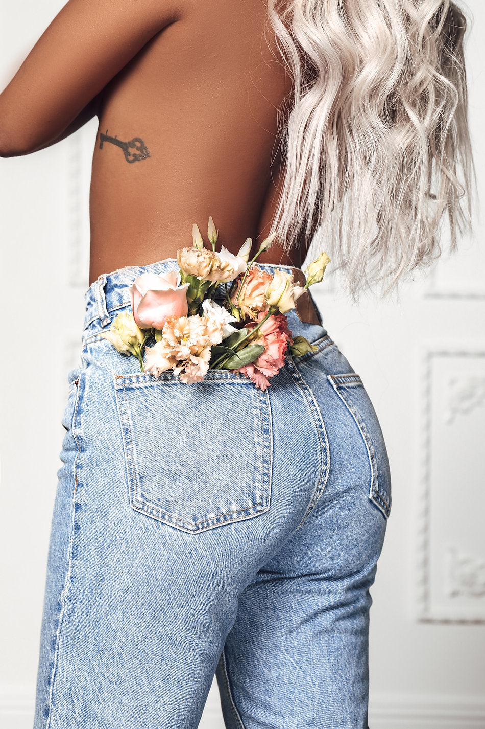 Model wearing blonde balayage 24-inch HD lace human hair wig in body wave texture – Nuola Wigs.