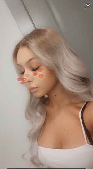 Model wearing blonde balayage 24-inch HD lace human hair wig in body wave texture – Nuola Wigs.