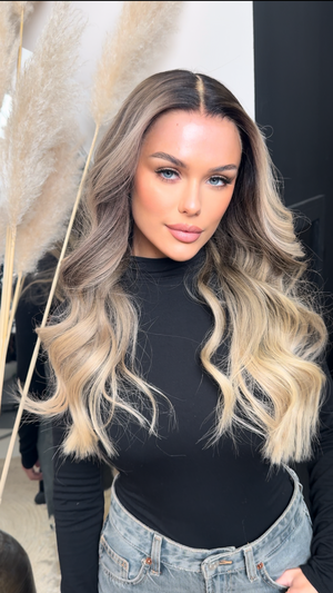 Model wearing blonde balayage 24-inch HD lace human hair wig in body wave texture – Nuola Wigs.