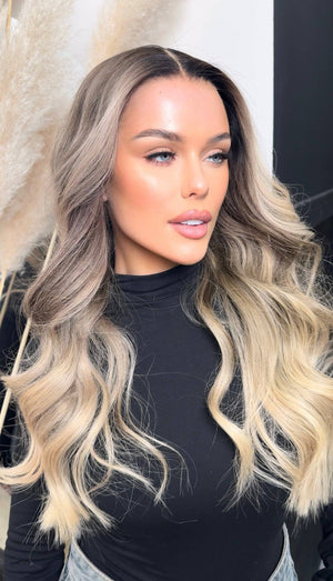 Model wearing blonde balayage 24-inch HD lace human hair wig in body wave texture – Nuola Wigs.