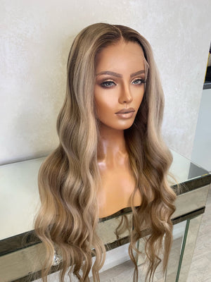 Model wearing blonde balayage 24-inch HD lace human hair wig in body wave texture – Nuola Wigs.