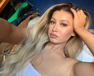 Model wearing blonde balayage 24-inch HD lace human hair wig in body wave texture – Nuola Wigs.