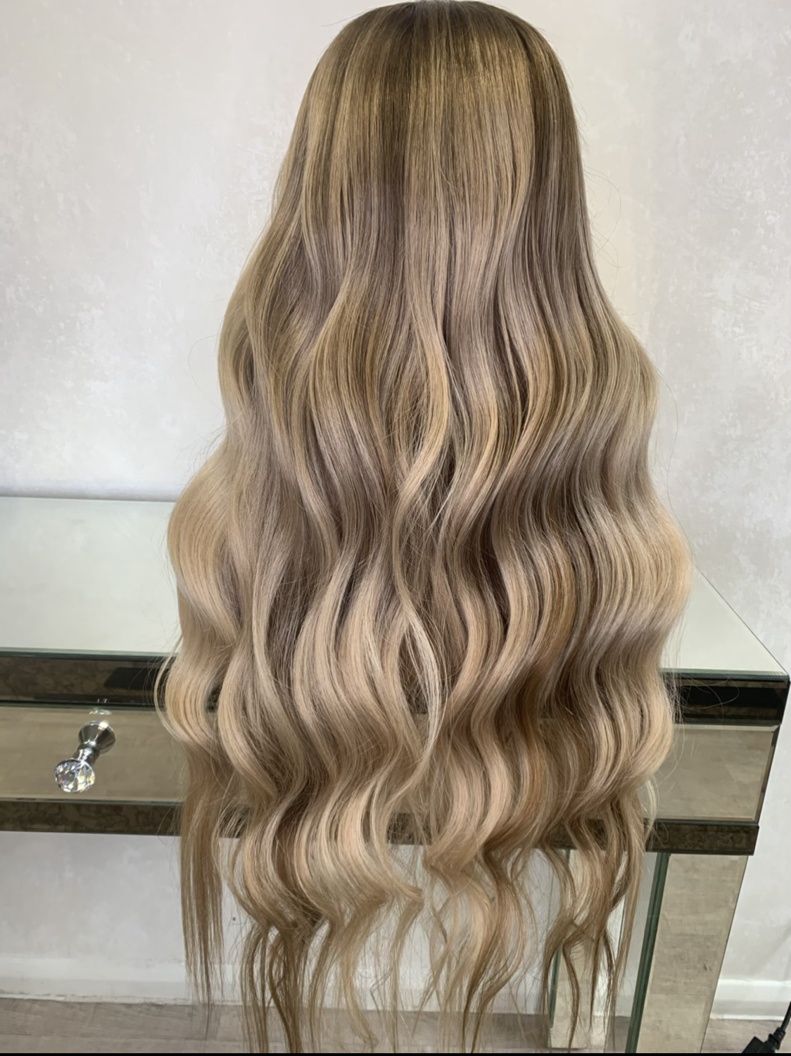 Model wearing blonde balayage 24-inch HD lace human hair wig in body wave texture – Nuola Wigs.