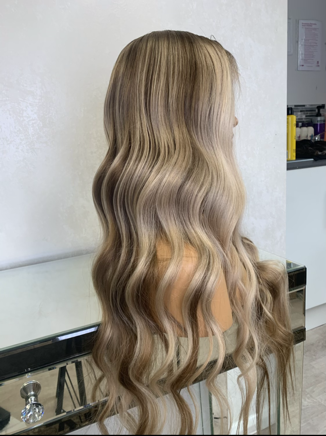 Model wearing blonde balayage 24-inch HD lace human hair wig in body wave texture – Nuola Wigs.