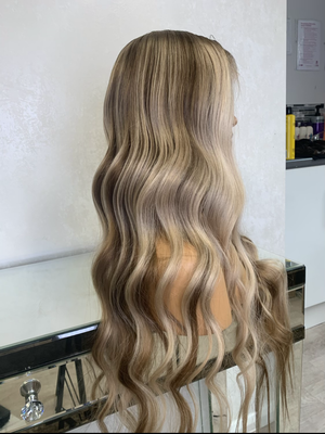 Model wearing blonde balayage 24-inch HD lace human hair wig in body wave texture – Nuola Wigs.