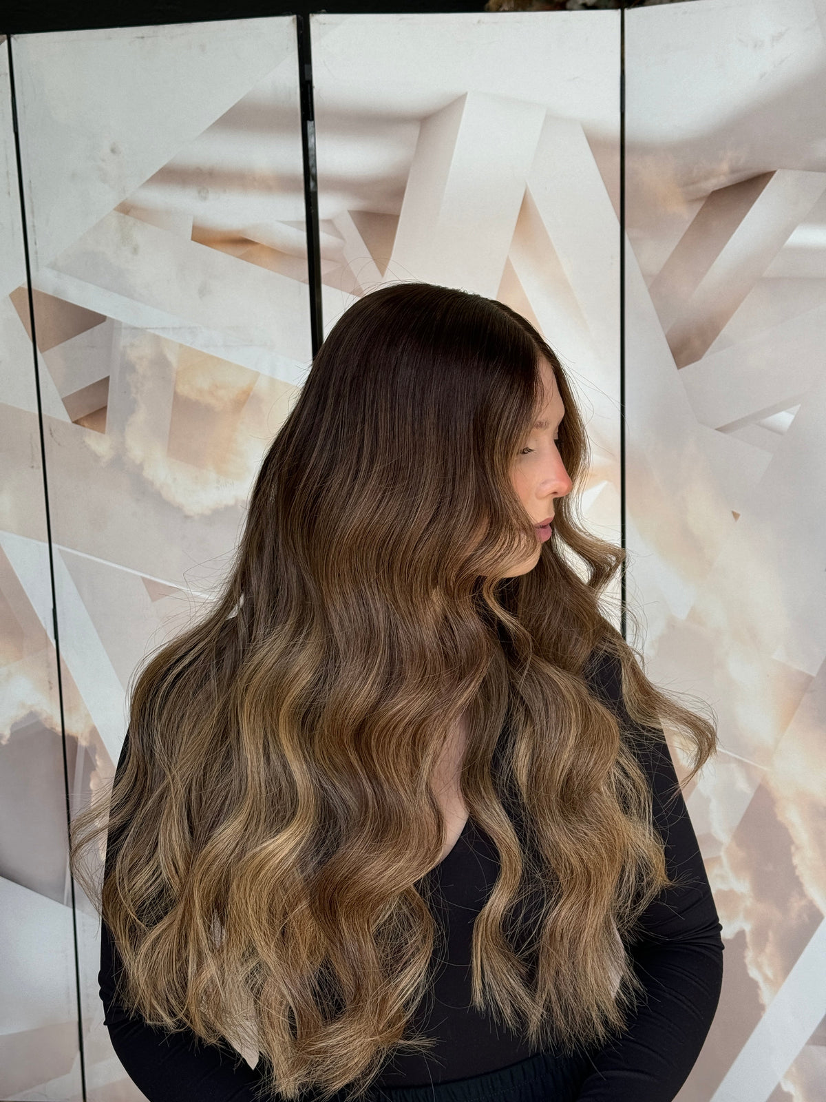 Model wearing blonde balayage 24-inch HD lace human hair wig in body wave texture – Nuola Wigs.