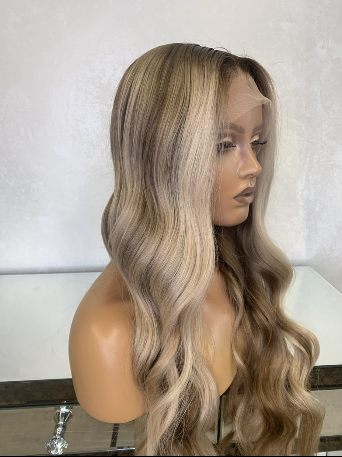 Model wearing blonde balayage 24-inch HD lace human hair wig in body wave texture – Nuola Wigs.