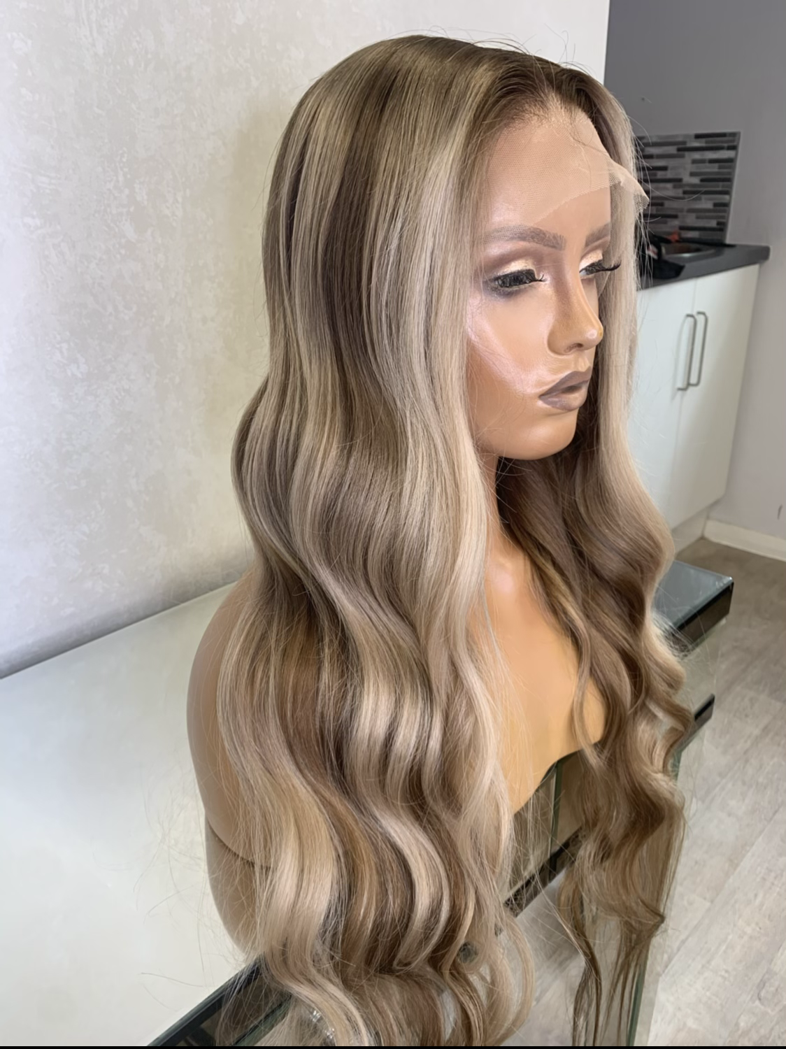 Model wearing blonde balayage 24-inch HD lace human hair wig in body wave texture – Nuola Wigs.