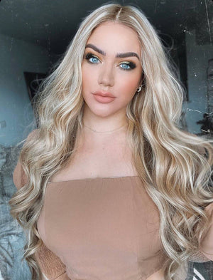Model wearing blonde balayage 24-inch HD lace human hair wig in body wave texture – Nuola Wigs.