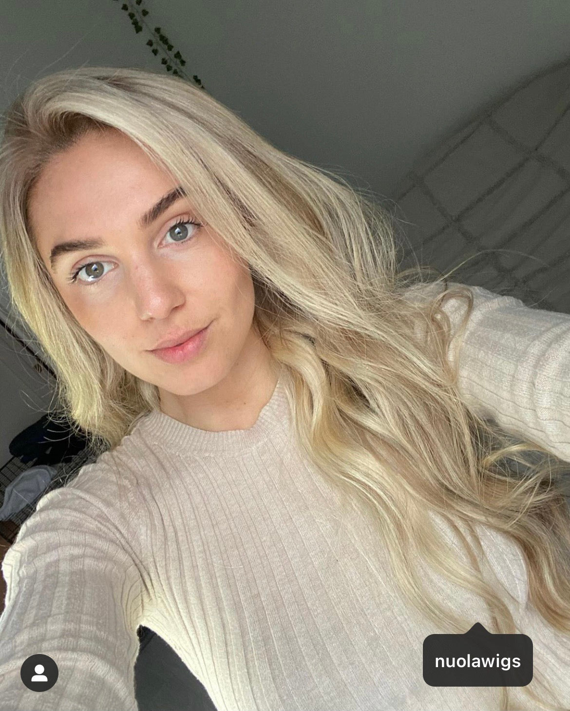 Model wearing blonde balayage 24-inch HD lace human hair wig in body wave texture – Nuola Wigs.