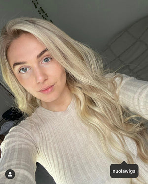 Model wearing blonde balayage 24-inch HD lace human hair wig in body wave texture – Nuola Wigs.