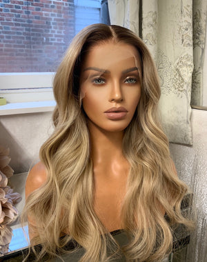 Model wearing blonde balayage 24-inch HD lace human hair wig in body wave texture – Nuola Wigs.