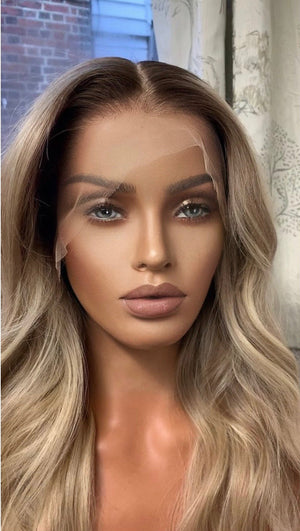 Model wearing blonde balayage 24-inch HD lace human hair wig in body wave texture – Nuola Wigs.
