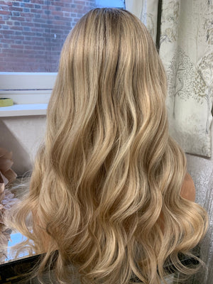 Model wearing blonde balayage 24-inch HD lace human hair wig in body wave texture – Nuola Wigs.