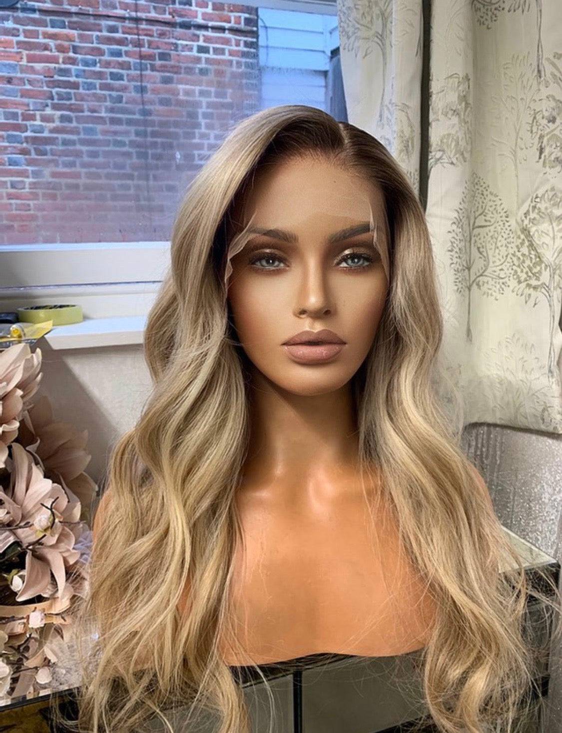 Model wearing blonde balayage 24-inch HD lace human hair wig in body wave texture – Nuola Wigs.