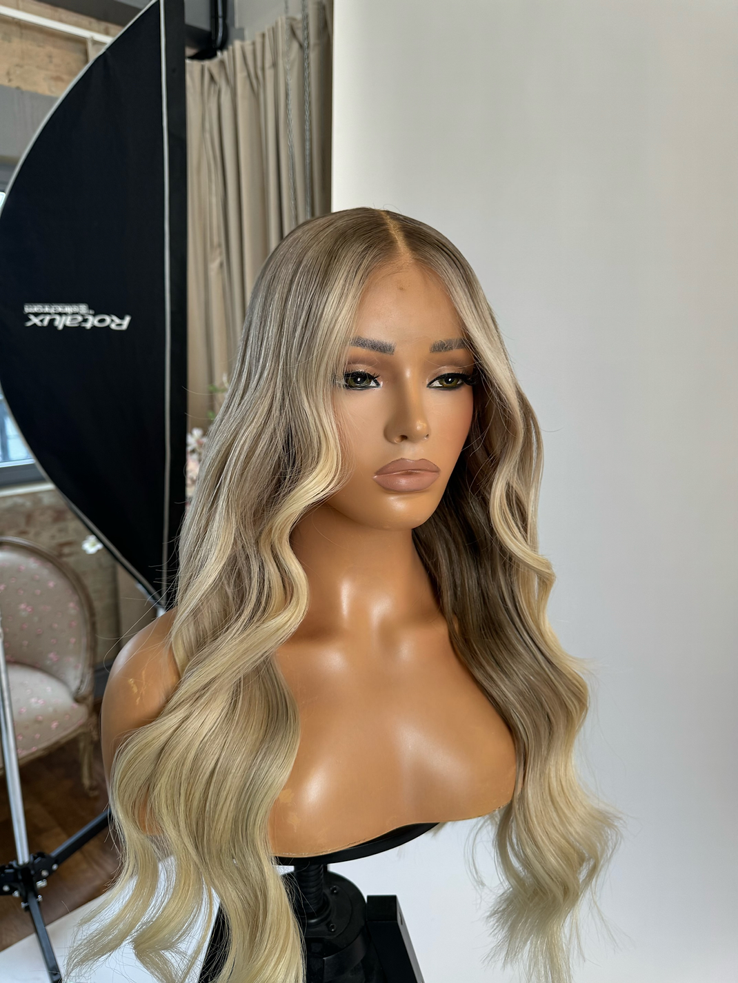 Model wearing blonde balayage 24-inch HD lace human hair wig in body wave texture – Nuola Wigs.